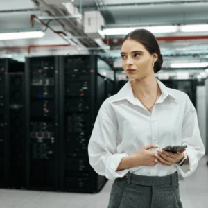 Woman supervises secure data center environment to ensure cyber managed services protect systems