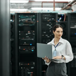 Woman monitoring servers illustrates what is network support today