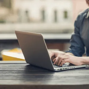 Person troubleshooting laptop network connection problems caused by a possible server failure event