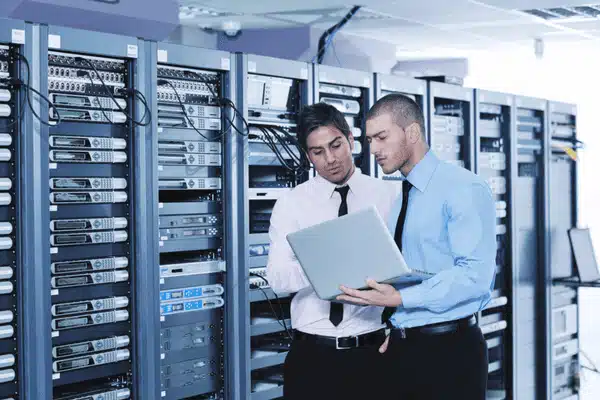 Two IT professionals analyze server performance, demonstrating proactive IT support in data management