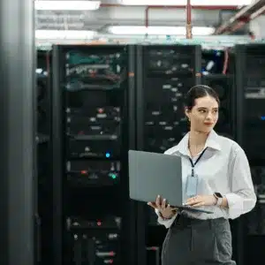 Woman monitoring servers illustrates what is network support today