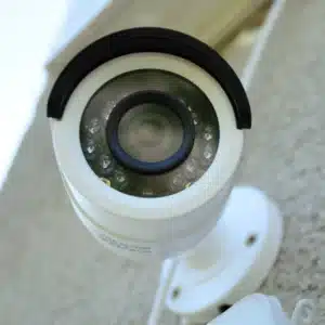 Close-up of wall-mounted security camera, highlighting infrared sensors for night vision during cctv maintenance procedures