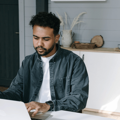 Professional works on laptop at home office, relying on managed it services for system stability